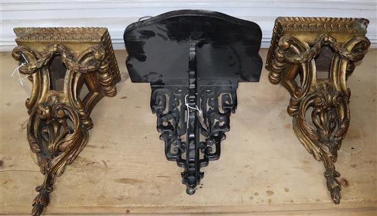 A pair of wall brackets, carved with acanthus leaves and laurel swags and an ebonised bracket